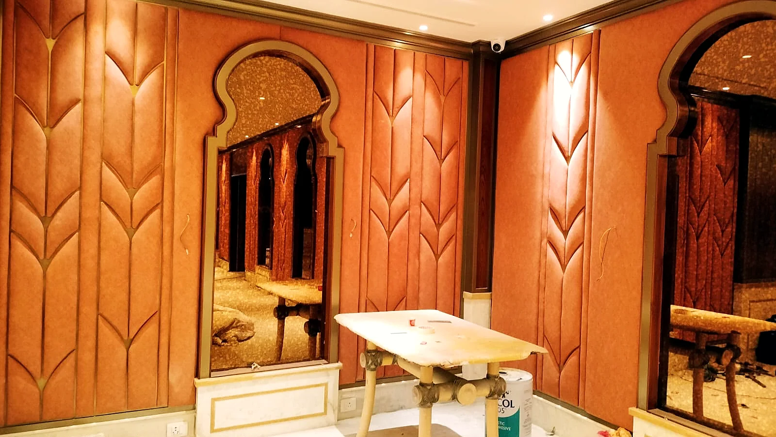 Panelled wall and layered ceiling lighting